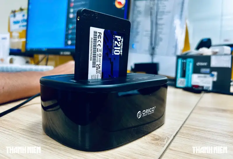 A user connecting an external SSD to a desktop PC tower