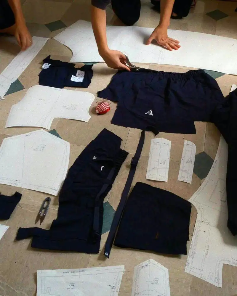 Rapper IO wearing custom Nike ACG x Khoki jacket and trousers